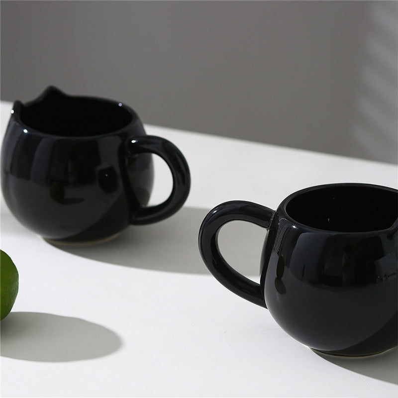 Adorable hand - painted cat - shaped ceramic mug, perfect for coffee or tea.