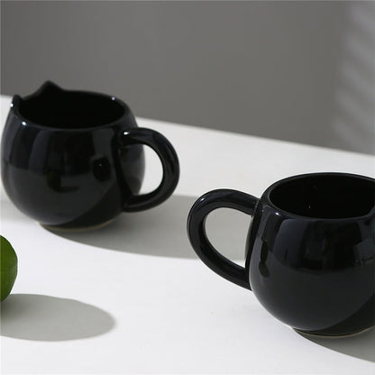 Adorable hand - painted cat - shaped ceramic mug, perfect for coffee or tea.