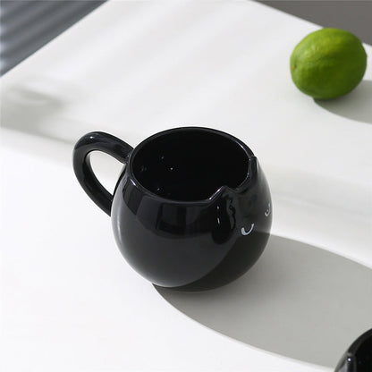 Adorable hand - painted cat - shaped ceramic mug, perfect for coffee or tea.